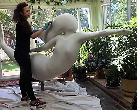 Artist Patricia Barnette sculpts the shape of the mermaid
