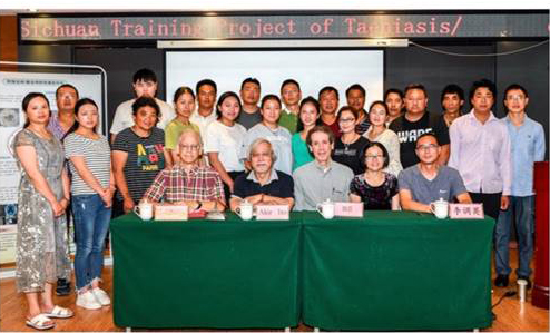 Picture of trainers and trainees in Xichang in front of table