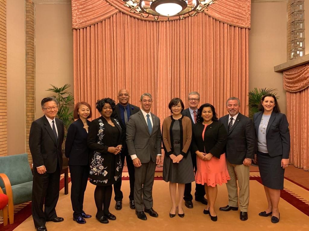 Ron Nireneberg, Mrs. Akie Abe, and staffers pose for a photo